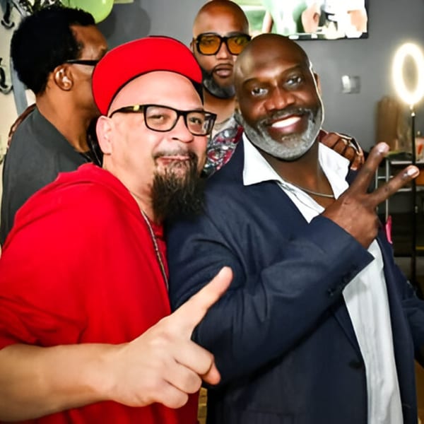 Two men smiling and posing for a photo at Jewlz Bar, Restaurant & Lounge.