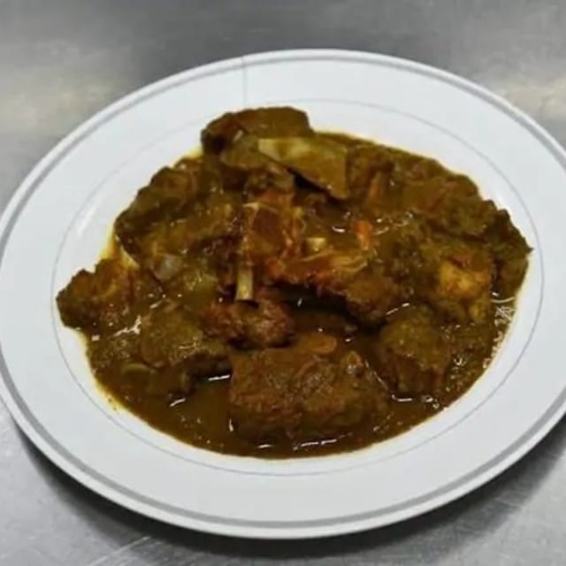 Curry Goat Rasta Paata Cabbage and Plantains.