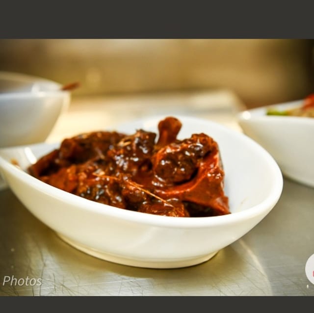 Oxtails Served with Rice & Peas Cabbage and Plantain.